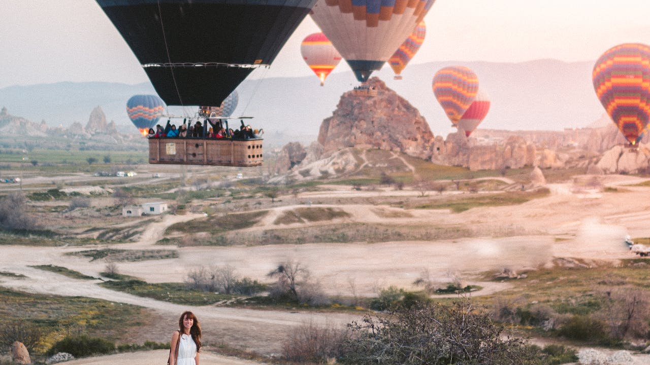 Woman standing under hot air balloons